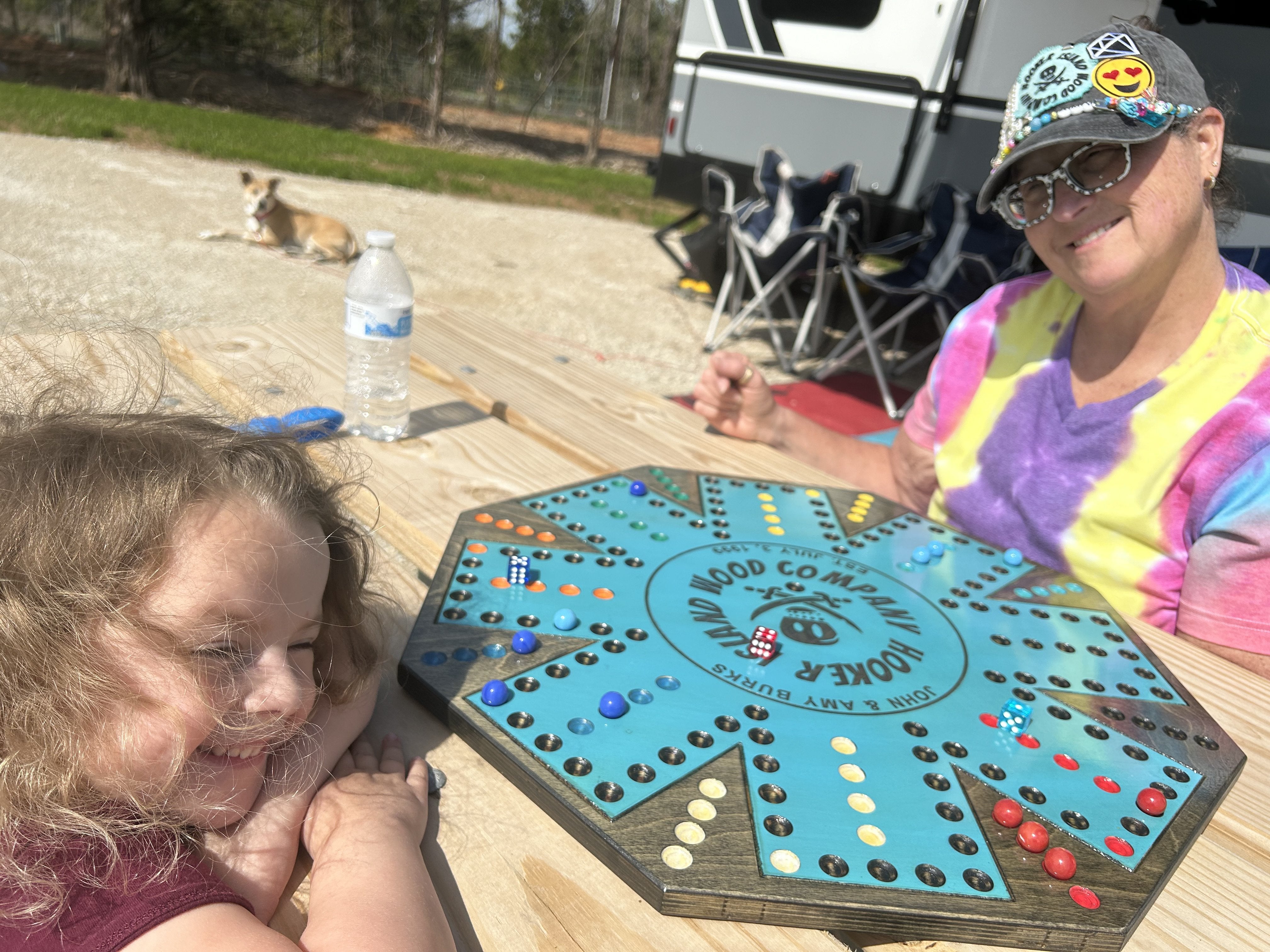 Amy and granddaughter playing wahoo at the campground with the dog