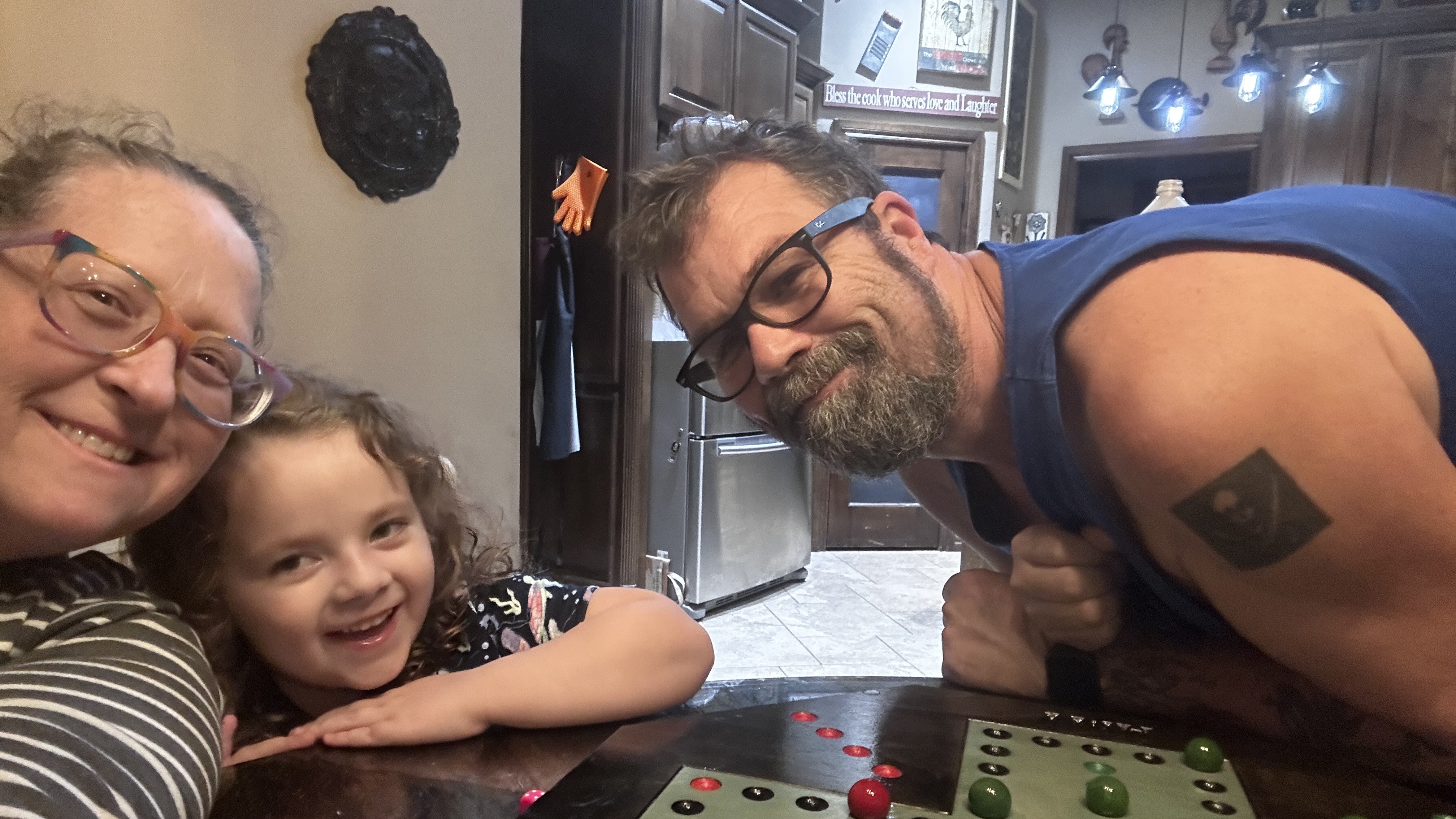 Two people playing a handcrafted HIWC wahoo board at a table
