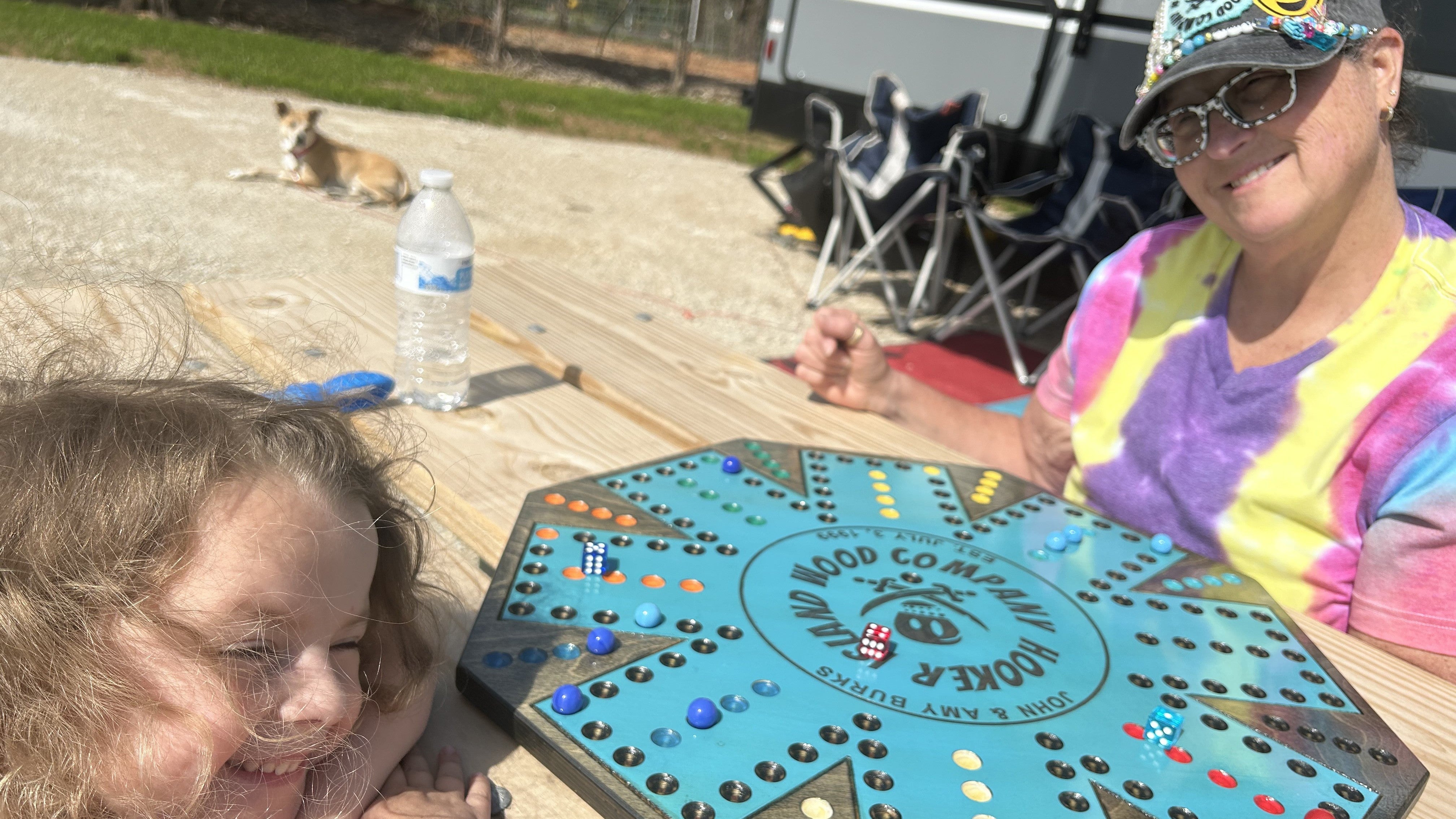 Family playing a Hooker Island Wood Company wahoo board at a campground